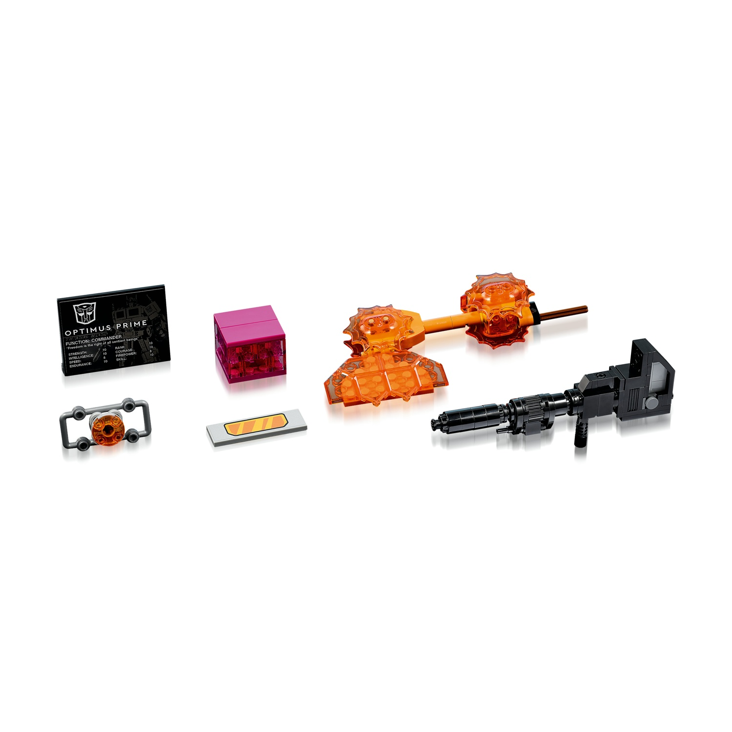 L'immagine presenta parti del giocattolo Optimus Prime: una pistola nera, armi energetiche arancioni, un cubo rosa, una carta e una cornice con un cerchio arancione.