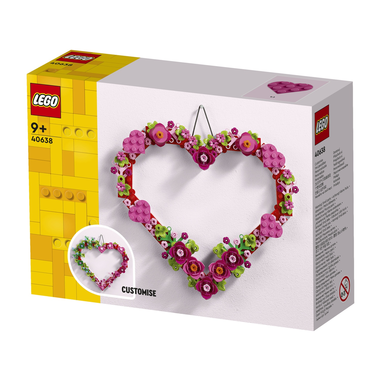 Una scatola Lego con una ghirlanda floreale a forma di cuore. La scatola è gialla e bianca, con il logo Lego e l'età.
