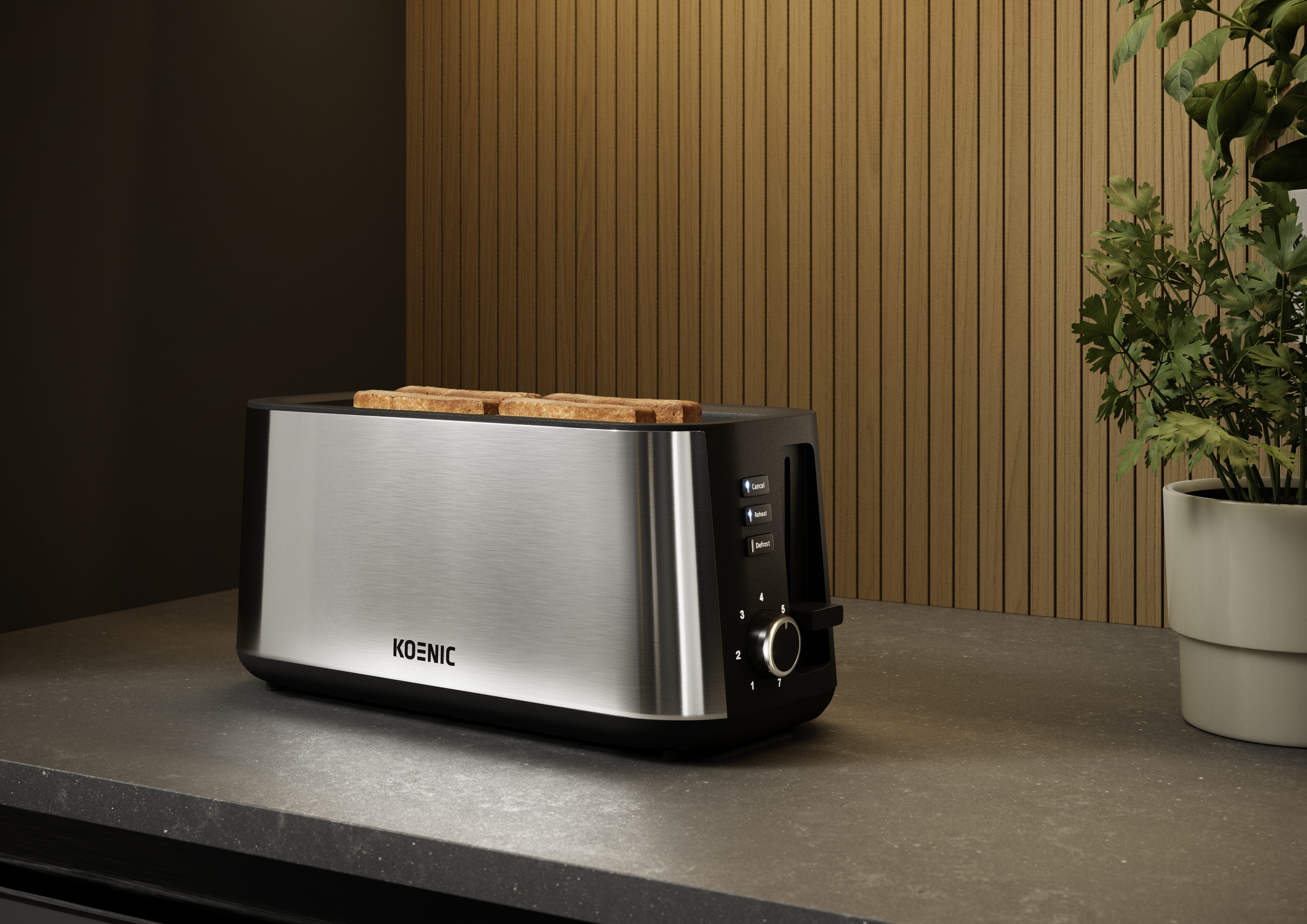 Srebrno-czarny toster z tostami w środku stoi na blacie. Roślina po prawej, a w tle drewniane panele.