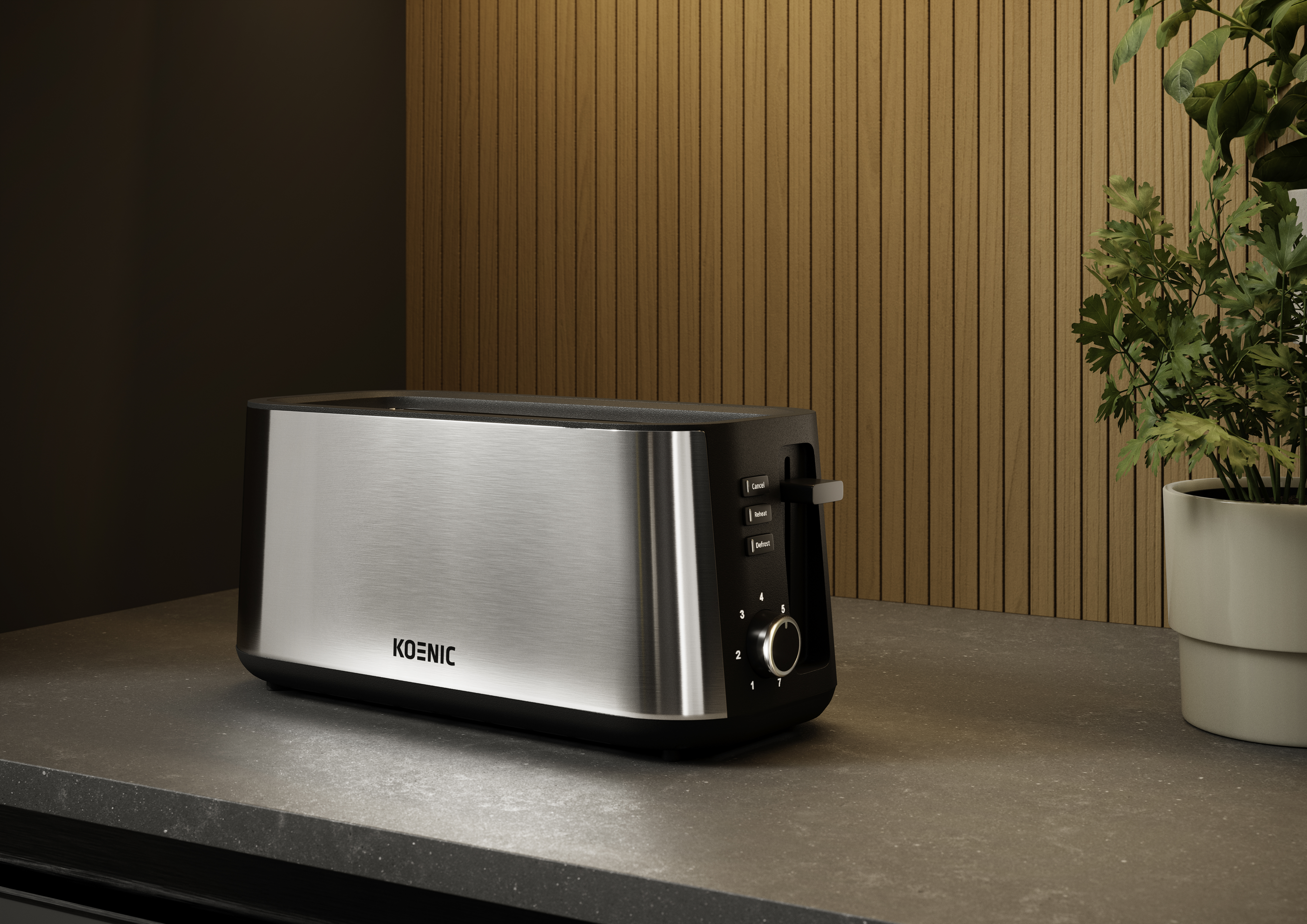 Srebrno-czarny toster Koenic stoi na blacie. Roślina po prawej stronie. Drewniane panele w tle.