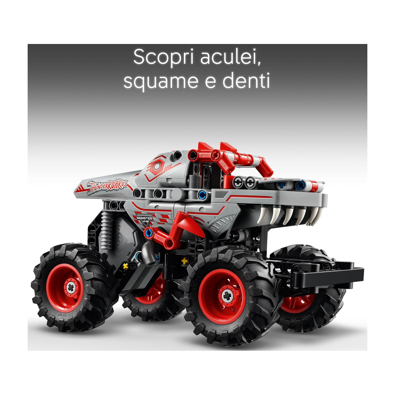 Un monster truck giocattolo grigio e rosso con grandi pneumatici neri. Il camion ha un design a forma di dente e le parole 'THUNDERROARS'.