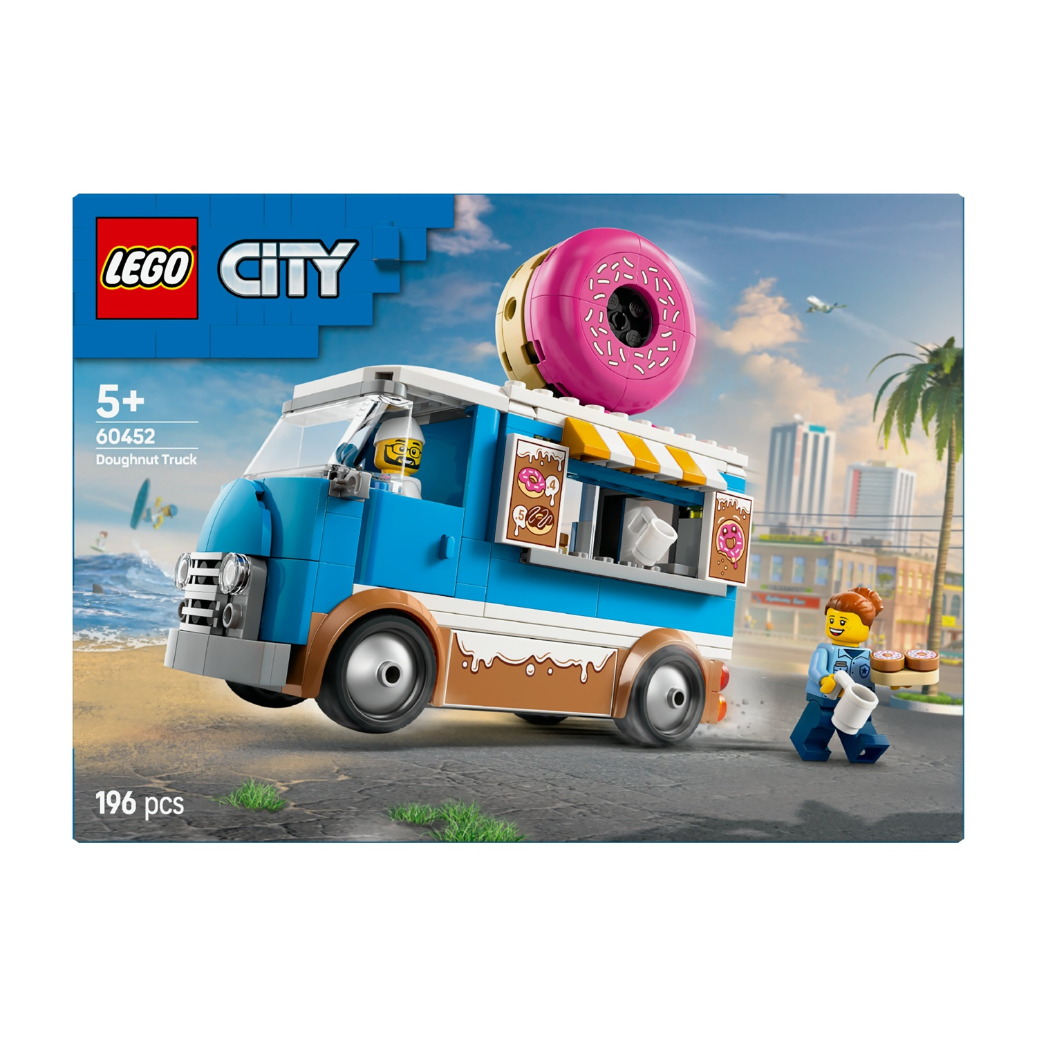 Camioncino di ciambelle Lego City con una grande ciambella rosa sopra. Una minifigure è nel camion. Un'altra minifigure trasporta ciambelle.
