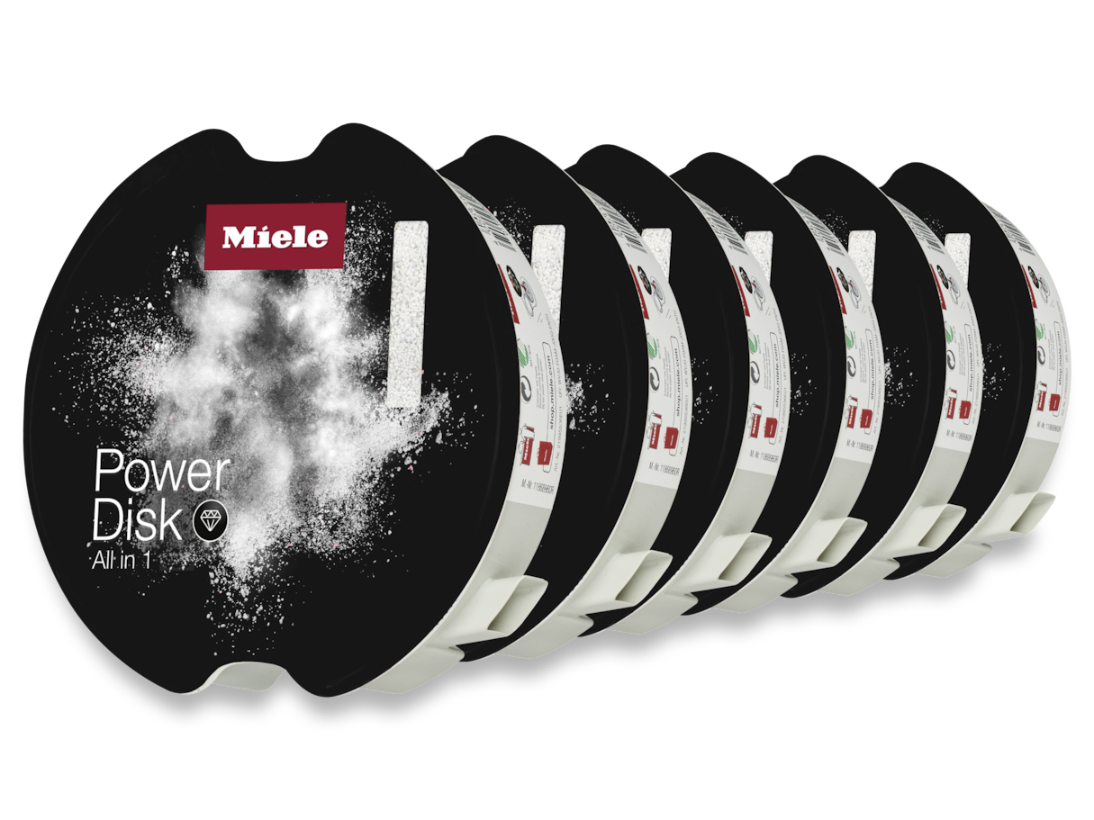 Siete discos Miele Power negros con polvo blanco y logotipo. Fondo blanco. Cada disco tiene una base blanca.