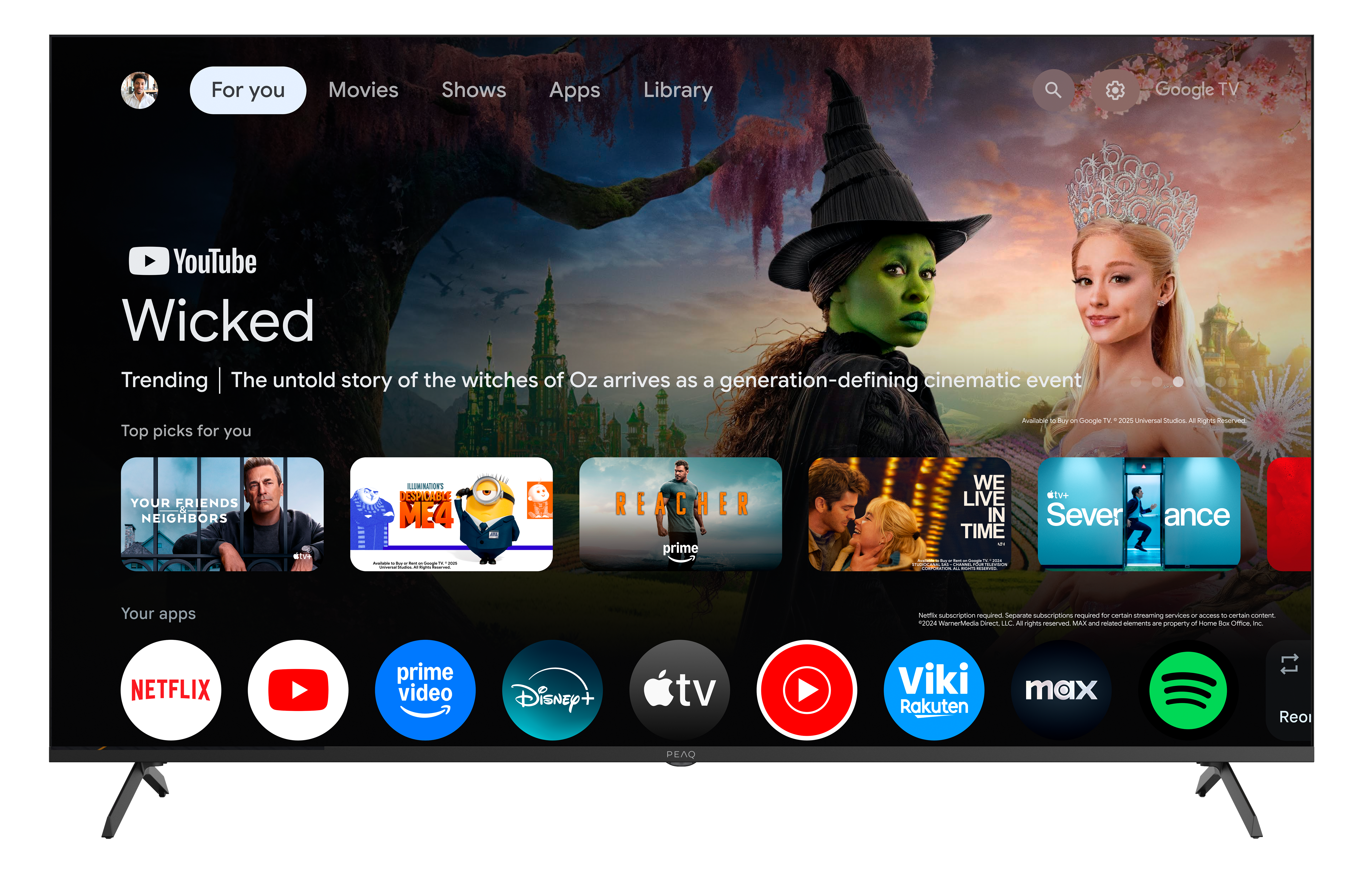 Ekran telewizora wyświetla Wicked z YouTube. Zawiera opcje filmowe i ikony aplikacji, takie jak Netflix i Prime Video.