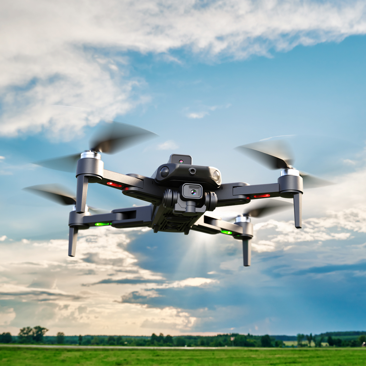 Siyah bir drone, bulutlu mavi bir gökyüzünde uçuyor. Arka planda yeşil bir alan ve ağaçlar var.