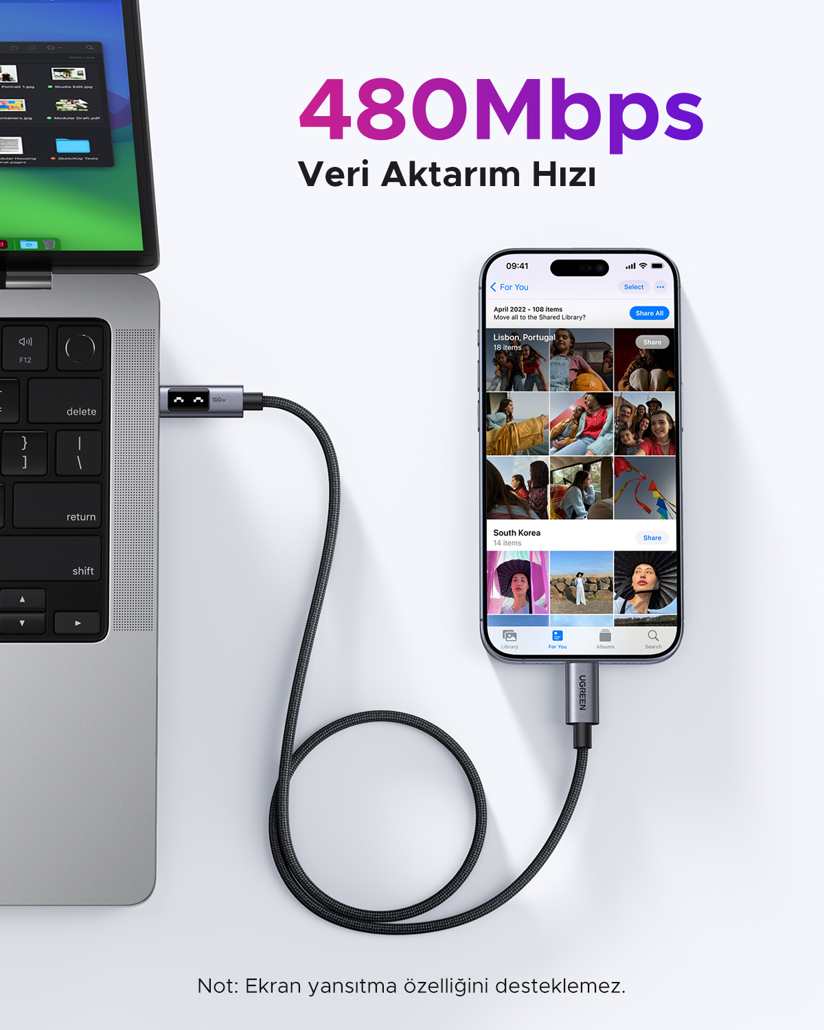 Dizüstü bilgisayar, iPhone ve kablo. Dizüstü ekranında dosyalar gösteriliyor. iPhone'da fotoğraflar var. Kablo cihazları bağlıyor.