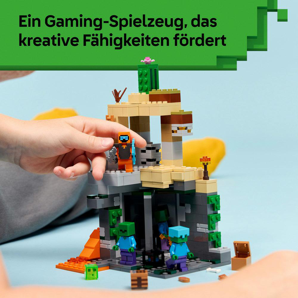 Ein Lego Minecraft-Set. Eine Hand hält eine Figur. Andere Charaktere und Strukturen befinden sich im Hintergrund. Grüner Text oben.
