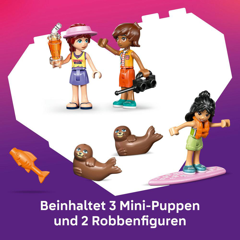 Das Bild zeigt drei Mini-Puppen, zwei Robben und einen Spielzeugfisch. Die Puppen tragen Sommerkleidung. Die Robben sind braun. Ein Mädchen surft.