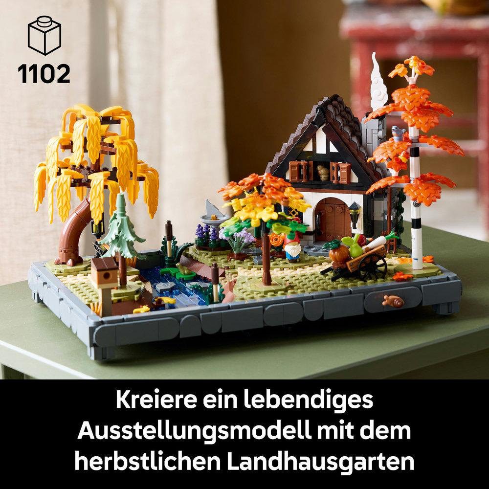 Ein Lego-Modell eines Hauses und Gartens in Herbstfarben. Enthält Bäume, einen Bach und einen kleinen Wagen.