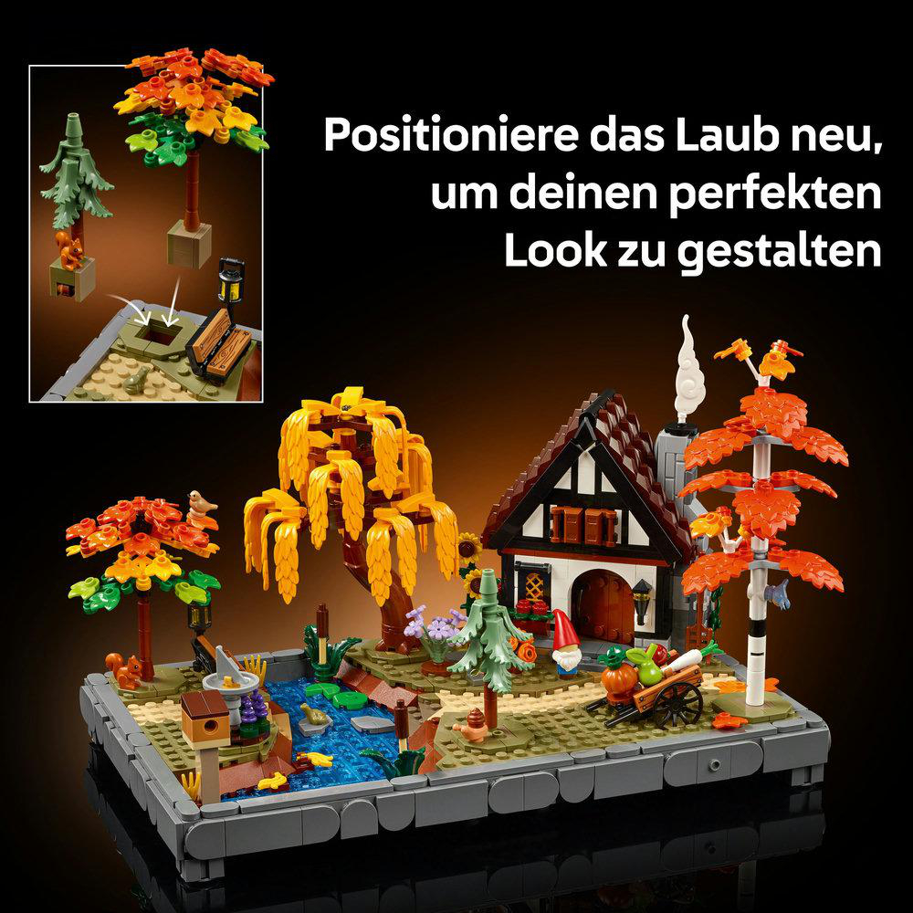 Ein Lego-Diorama zeigt ein Haus, Bäume, einen Teich und einen Wagen. Die Szene umfasst verschiedene farbenfrohe Elemente und Details.
