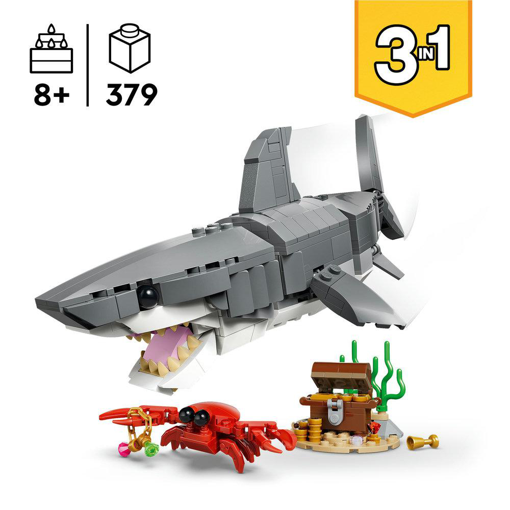 Ein Lego-Set zeigt einen grauen Hai, eine rote Krabbe, eine Schatztruhe und die Zahl 31. Es zeigt auch eine Box mit 8+ und 379.