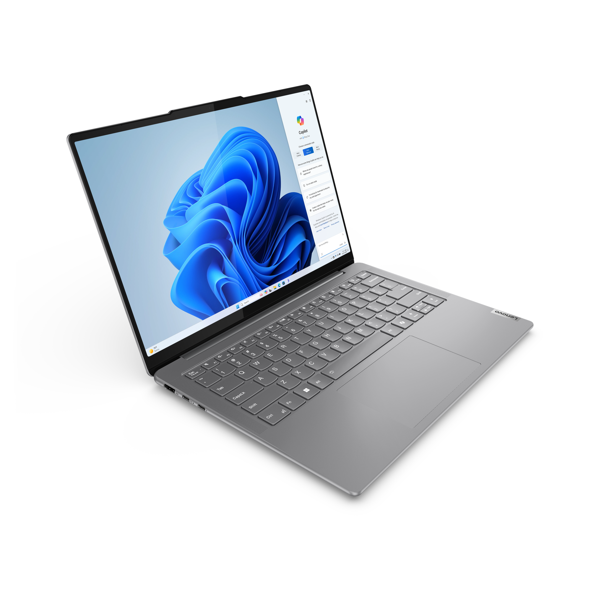Siyah bir yüzeyde açık gümüş renkli bir Lenovo dizüstü bilgisayar. Ekranda mavi arka planlı bir Windows arayüzü gösteriliyor.