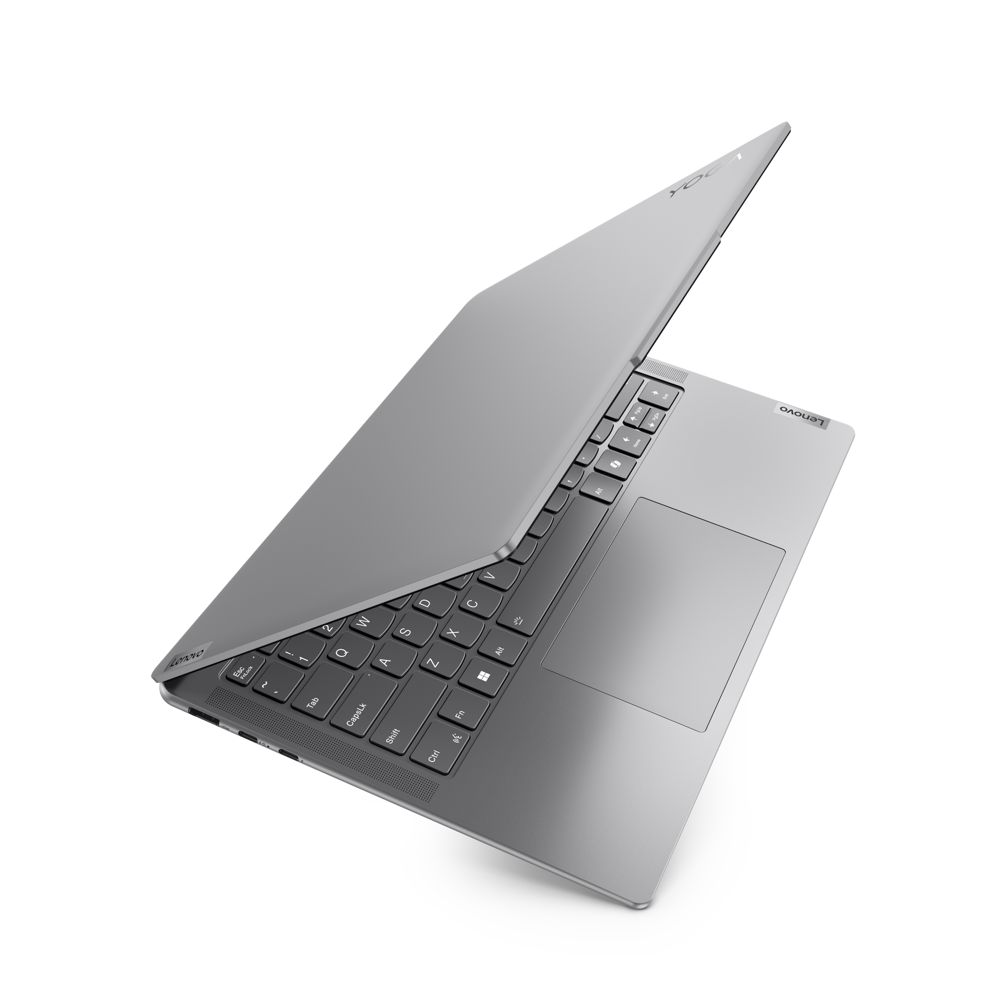 Siyah zemin üzerinde açık gümüş bir Lenovo Yoga dizüstü bilgisayar. Klavye ve dokunmatik yüzey görünür.