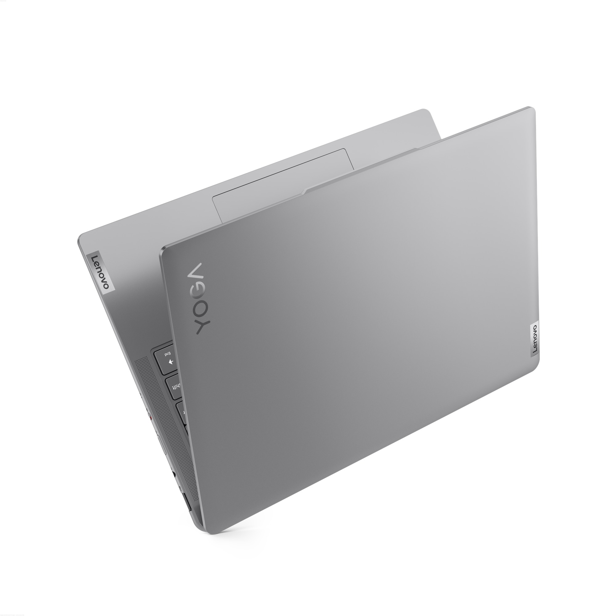 Siyah zemin üzerinde gri bir Lenovo Yoga dizüstü bilgisayar. Ekran açık. Klavye ve Yoga logosu görünür.