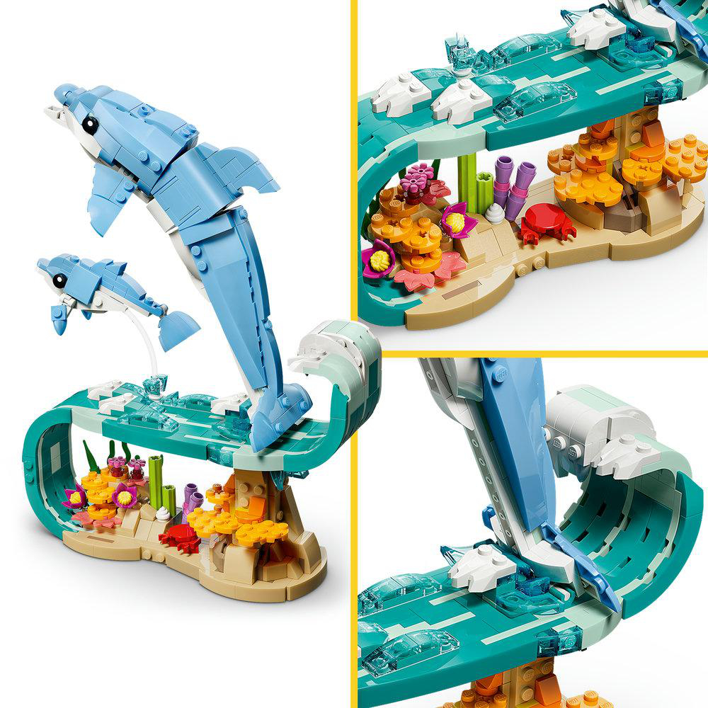 Ein Lego-Set mit blauen Delfinen, die über eine Welle springen. Korallen und Meeresbewohner sind in der Szene zu sehen.