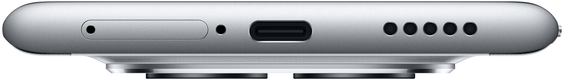 Dolna krawędź srebrnego urządzenia, z tacką SIM, portem i otworami głośnikowymi. Ma zaokrąglony koniec. Urządzenie jest srebrne.