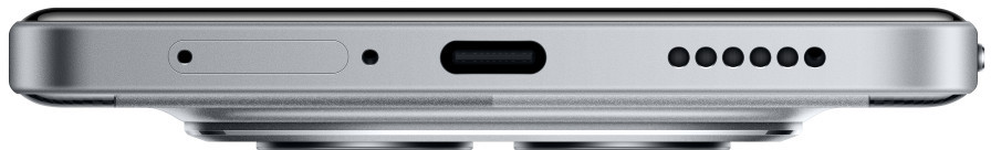 Srebrna krawędź telefonu z tacką SIM, otworem, portem USB-C i kilkoma otworami głośnikowymi. Spód ma zaokrąglony kształt.