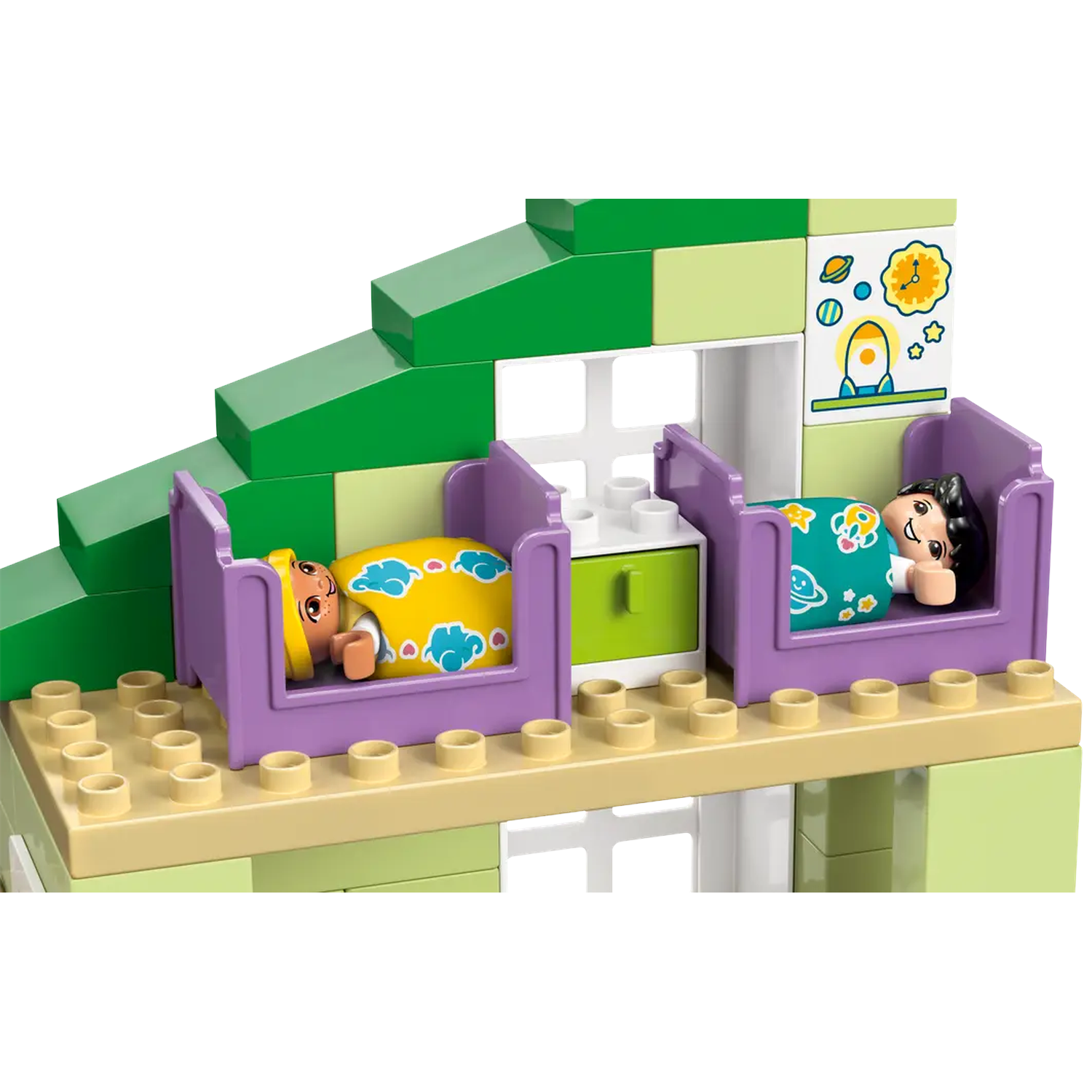 Toy house with two Lego figures in beds. The house is green and beige. One figure is yellow and the other has black hair.