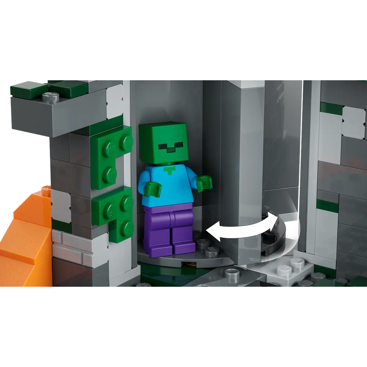 Een Minecraft Lego-set met een zombiefiguur. De scène bevat grijze en groene blokken en een oranje lavachtige structuur.