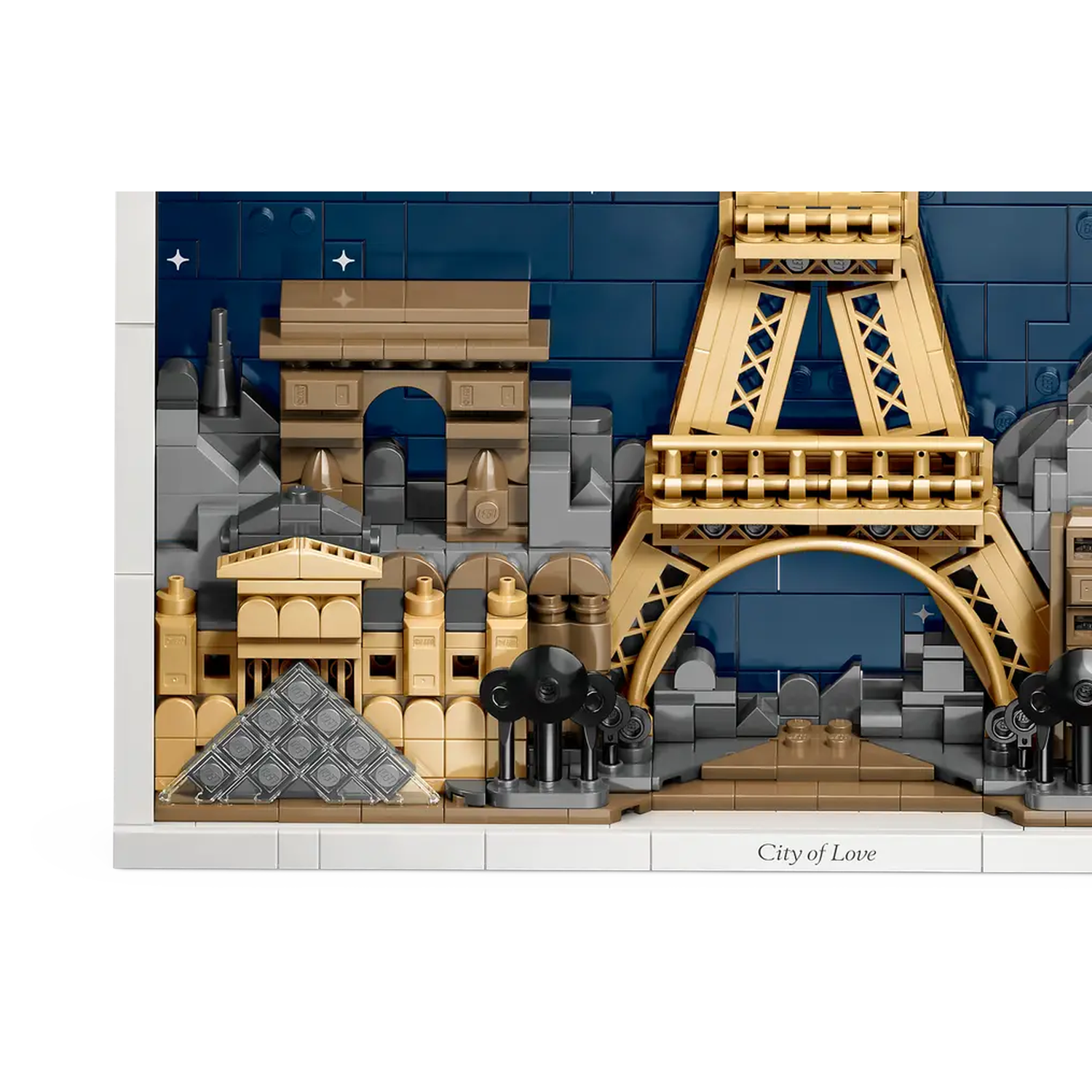 Lego model of Paris, including the Eiffel Tower, Arc de Triomphe, and Louvre Pyramid, against a dark blue brick background.