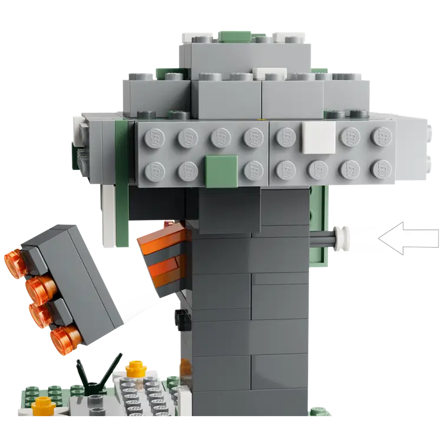 A Lego structure with gray, green, and orange blocks. An arrow points to a white cylinder. The structure sits on a green base.