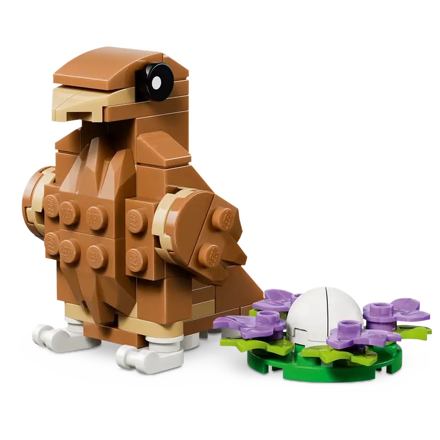 A Lego bird is brown, with a black eye. Next to it is a nest with a white egg and purple flowers.