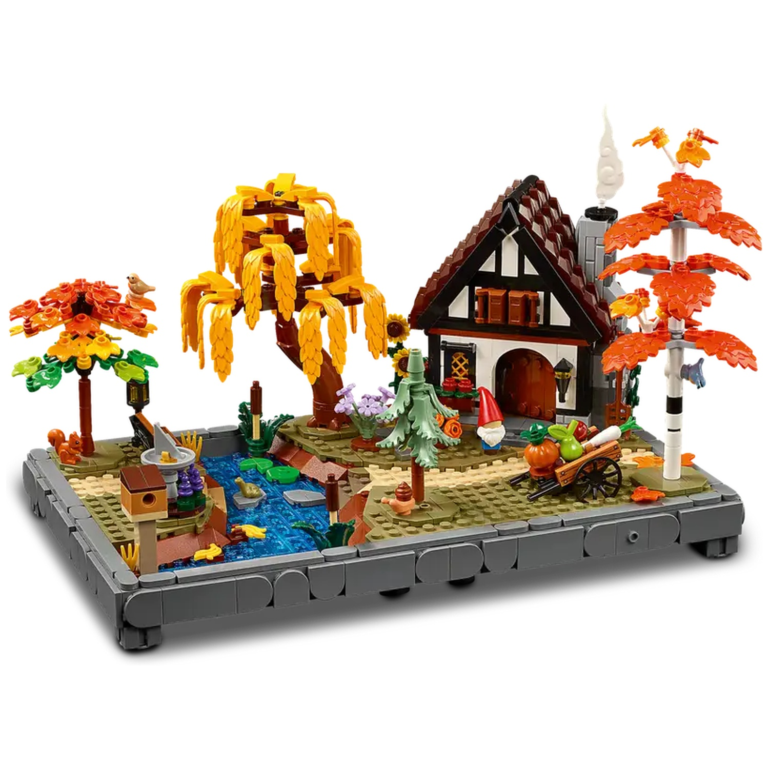 Un diorama Lego présente une maison, un étang et des arbres. Les couleurs d'automne sont présentes. Une petite charrette et un gnome sont dans la scène.