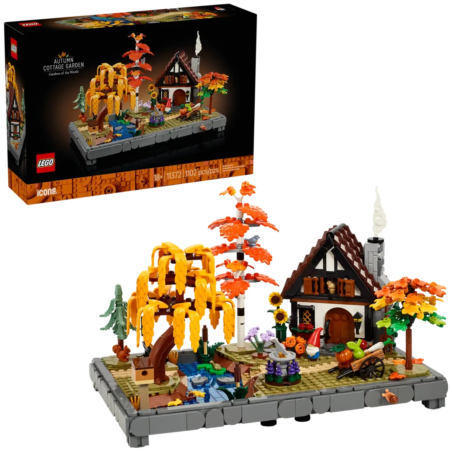 Ensemble Lego d'un jardin de cottage d'automne, avec un cottage, des arbres et une charrette. Une boîte est à gauche.