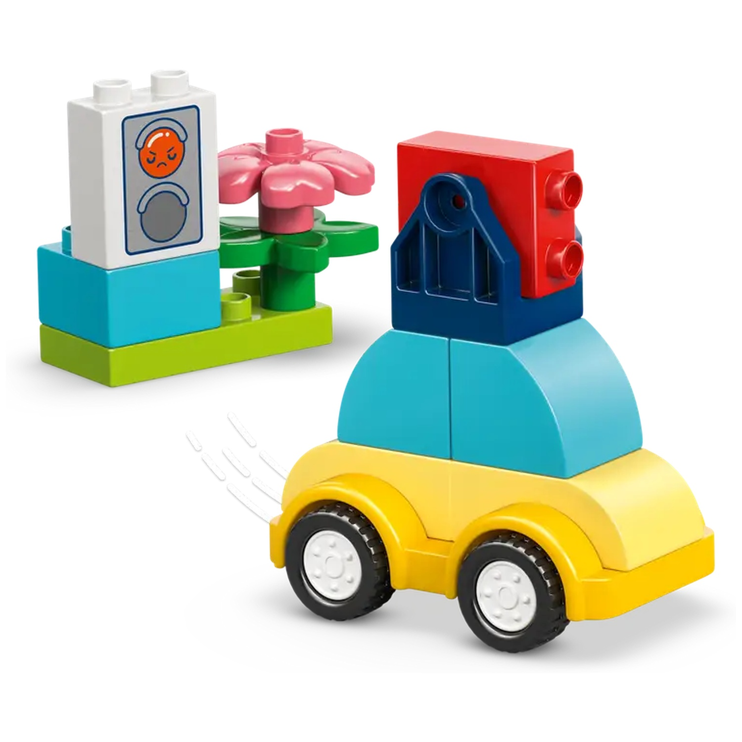 Blocs de jouets colorés : voiture, fleur et un bloc avec un visage. La voiture est jaune, bleue et rouge. La fleur est rose.