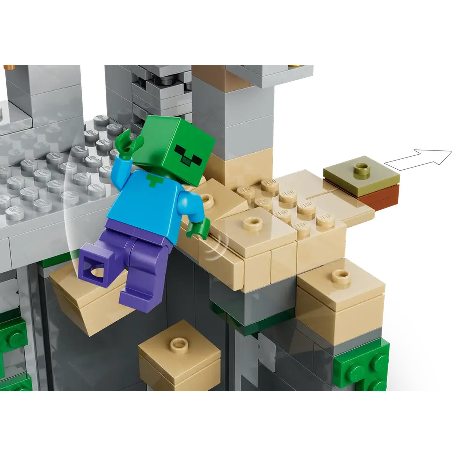 Une figurine Lego Minecraft avec une tête verte et une chemise bleue tombe. Des blocs Lego beiges et gris forment une structure.
