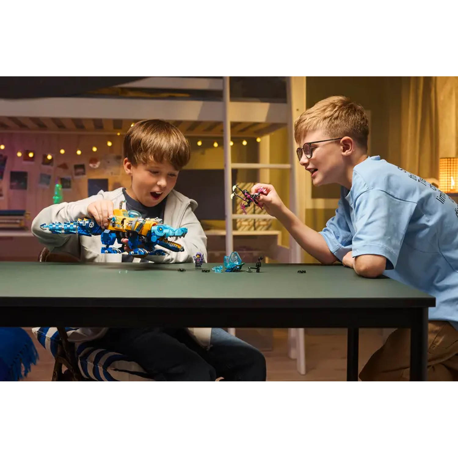 Two boys play with Lego toys at a table. One boy holds a blue and yellow dinosaur, the other holds a small toy.