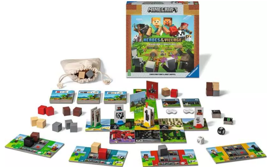 Minecraft-Brettspiel-Set. Box, Karten, Holzblöcke und Würfel werden angezeigt. Das Spiel heißt 'Heroes of the Village'.