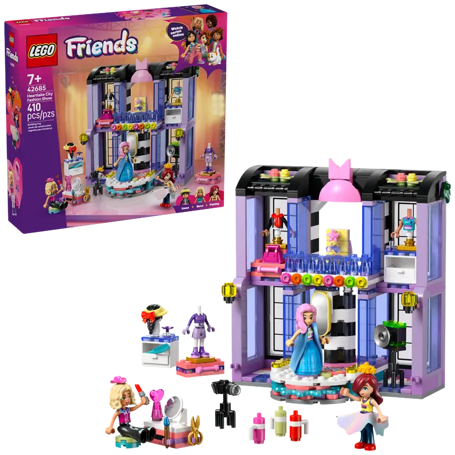 LEGO Friends set: Fashion show building with mini-figures. Includes accessories like cameras, makeup, and mannequins. The box is also present.