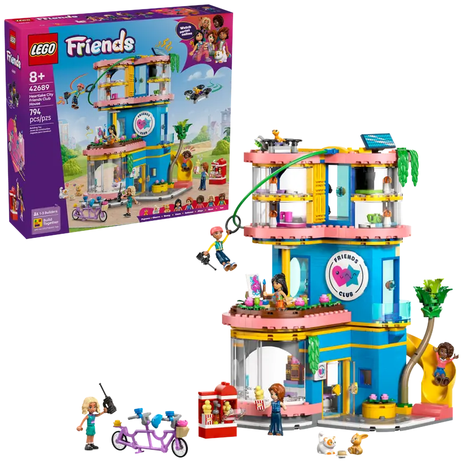Lego Friends set. Blue building with pink accents. Includes figures, accessories, a slide, and a tandem bike. Box art is on the left.