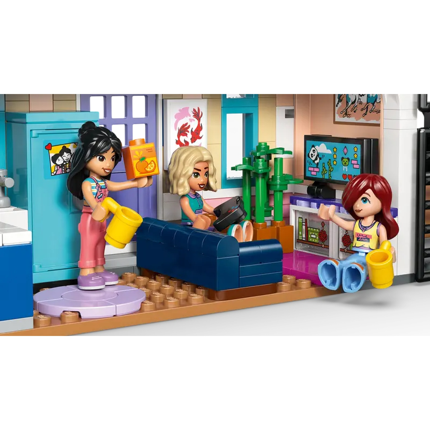 Lego scene with three figures. One holds a juice box. Another sits on a couch. The third sits with a yellow cup. TV in background.