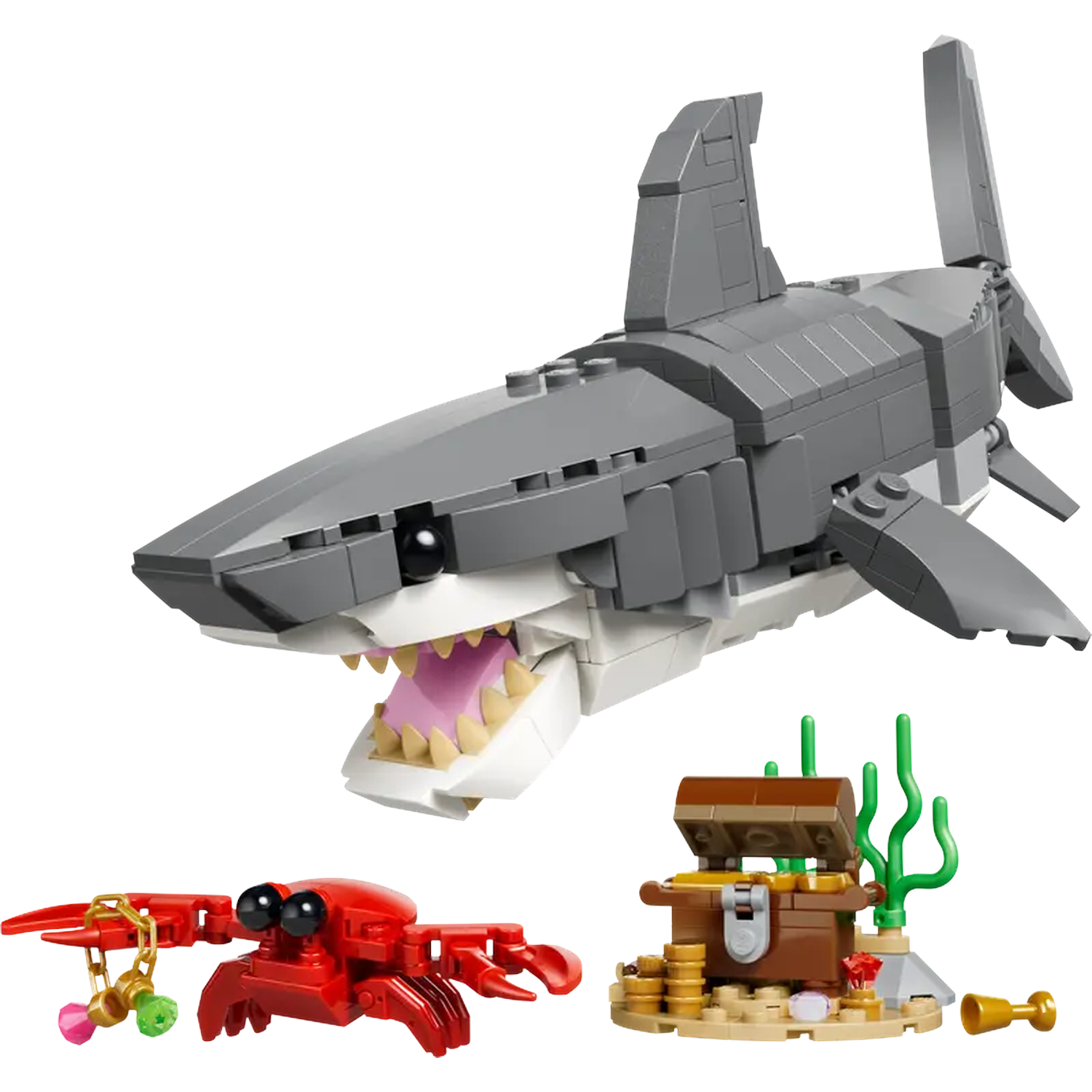 Een Lego set met een grijze haai, rode krab, schatkist met munten en gouden accessoires.