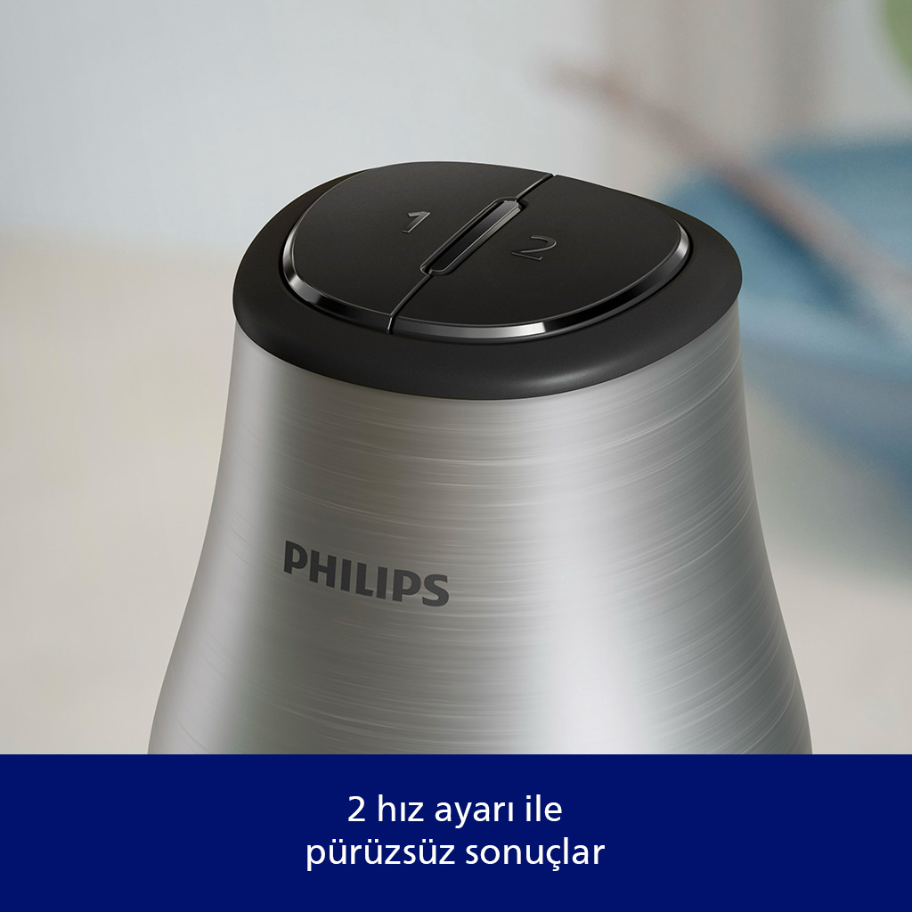 Siyah üst ve gümüş gövdeye sahip bir Philips blender. Üst kısımda 1 ve 2 hız ayarları var. Marka adı gövdede görünür.