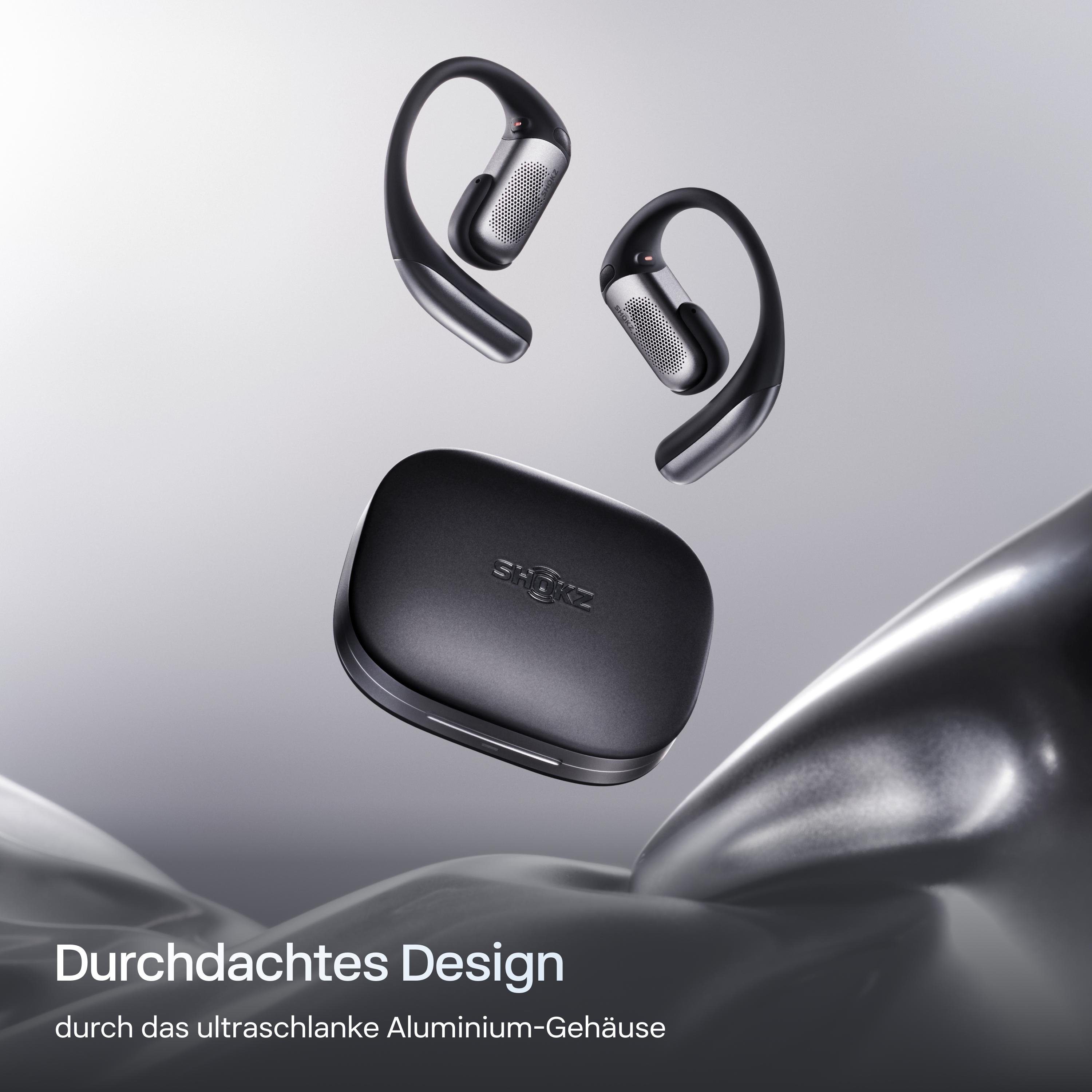 Schwarze Shokz-Kopfhörer und -Etui schweben. Der Text lautet 'Durchdachtes Design'.