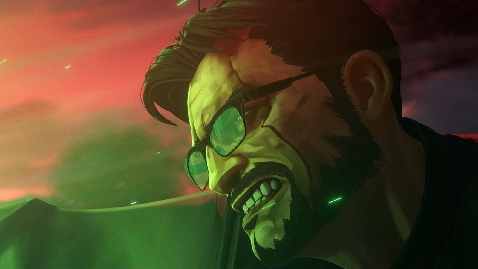 Nahaufnahme eines Mannes mit Brille, Bartstoppeln und einer Narbe. Der Hintergrund ist rot und grün, mit grünen Lichtern im Gesicht.