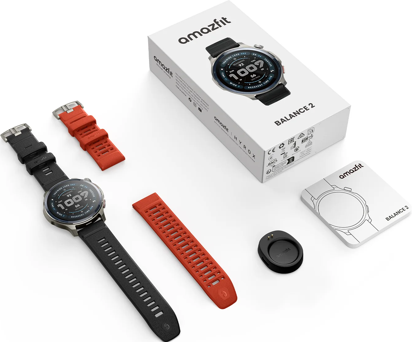 Uno smartwatch Amazfit Balance 2, cinturini neri e rossi, base di ricarica e scatola su una superficie bianca.