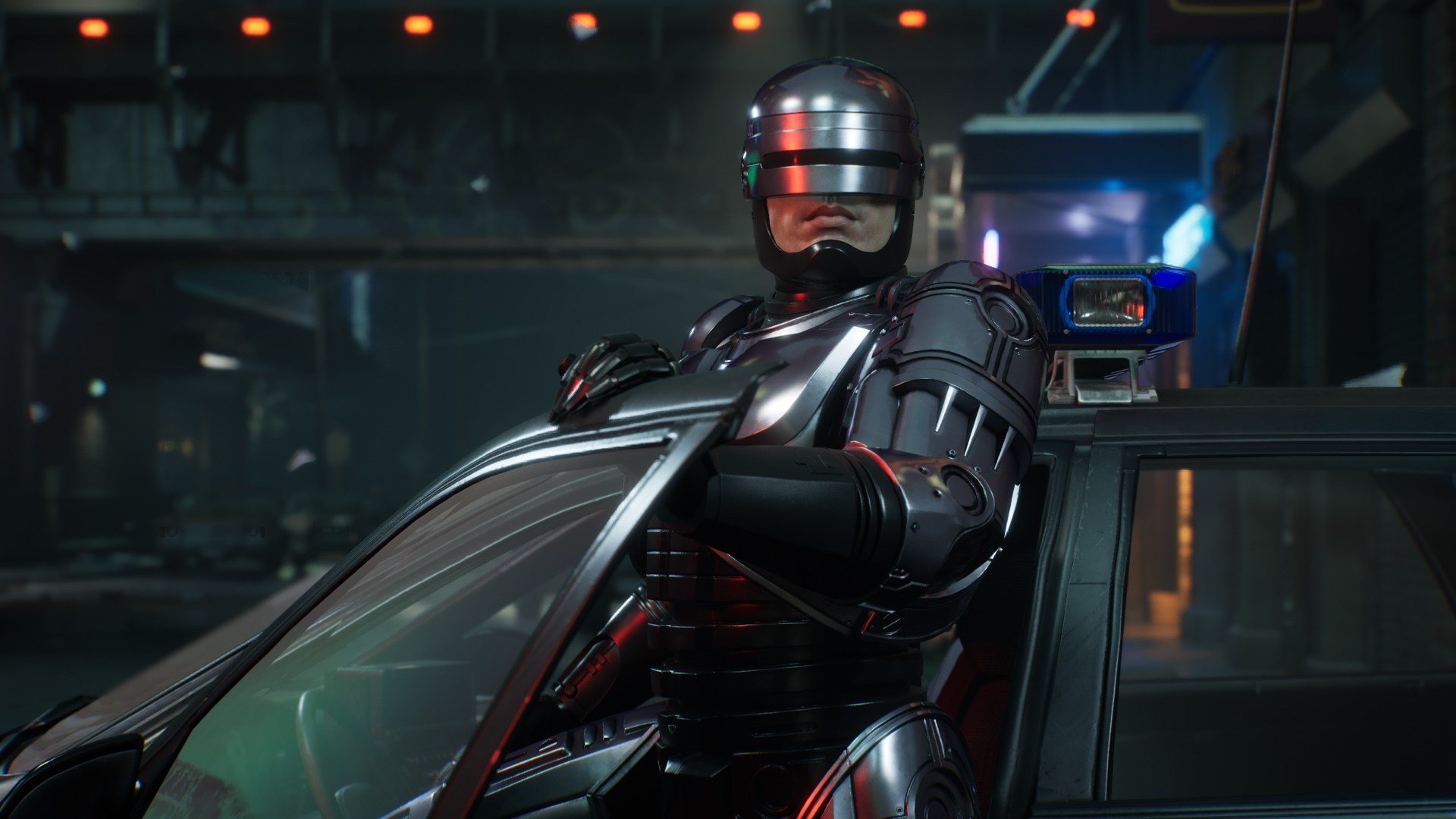 RoboCop se tient près d'une voiture de police. Il porte un costume métallique. Le fond montre une ville nocturne.