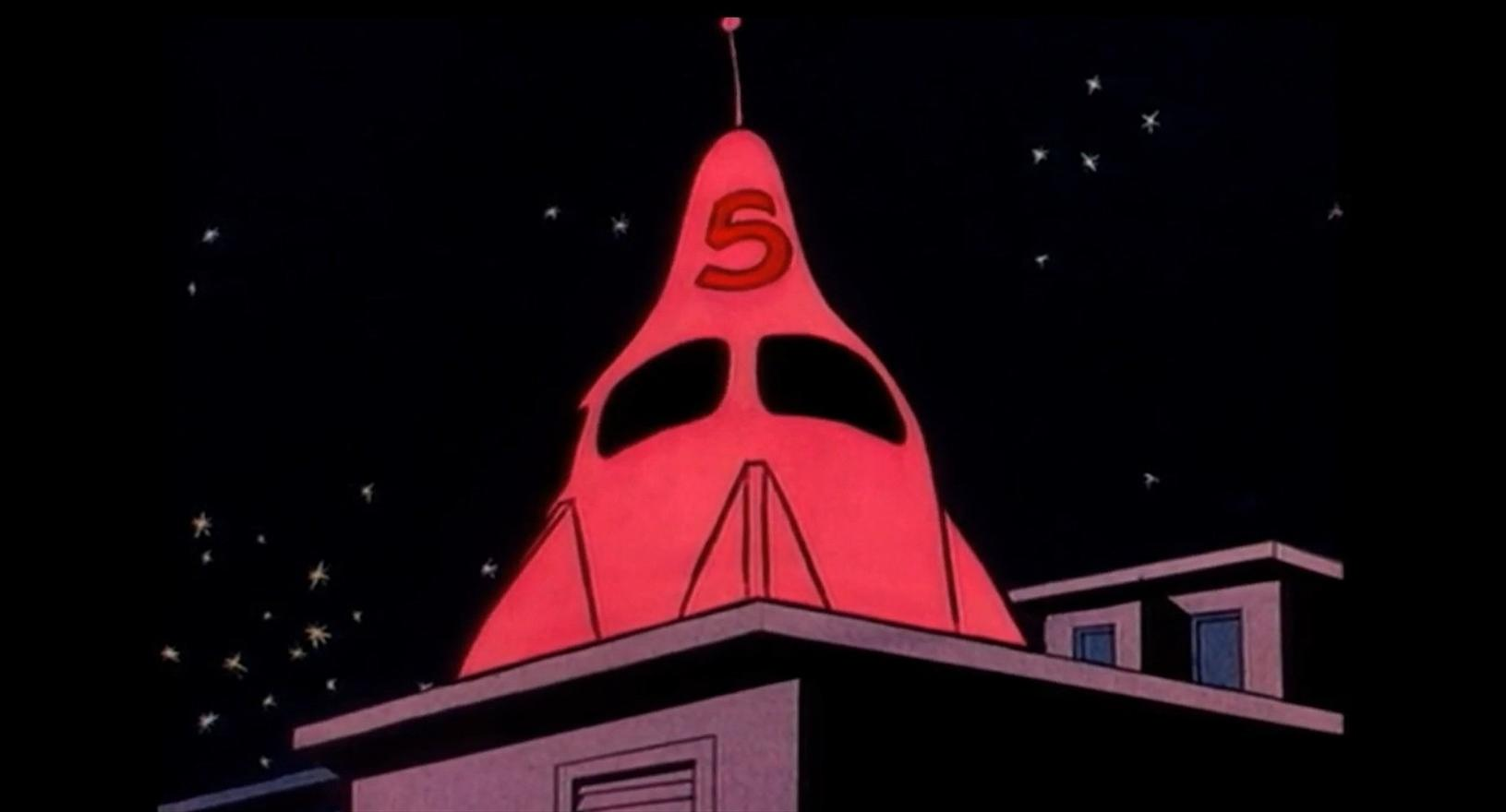 Ein roter, raketenförmiger Turm mit einer großen '5' darauf, vor einem dunklen Sternenhimmel.