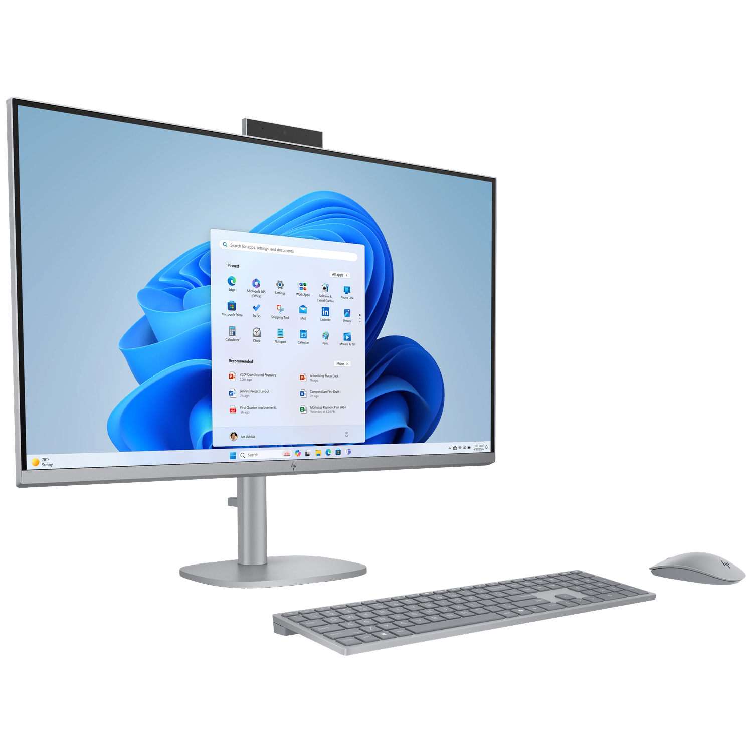 Silver all-in-one computer with keyboard and mouse on a white background. Windows 11 interface displayed.