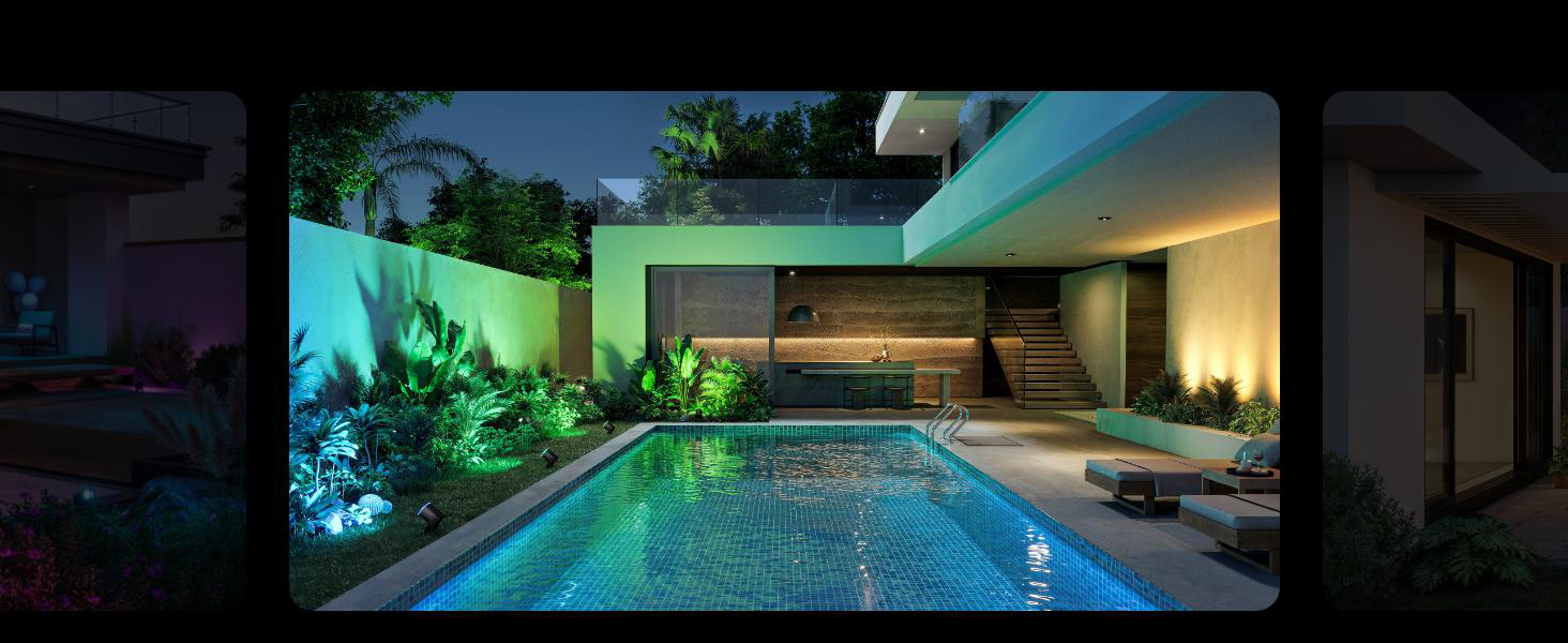 Modernes Haus mit Pool bei Nacht, beleuchtet von bunten Lichtern.