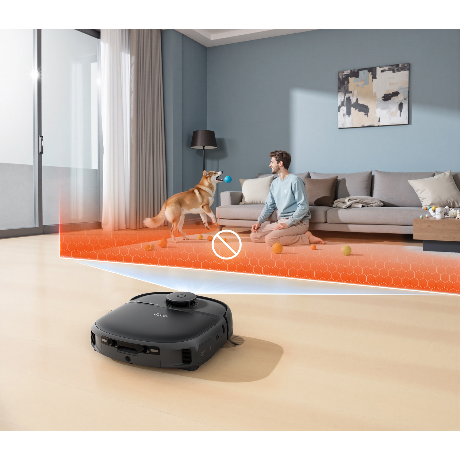 Un aspirateur robot noir navigue dans un salon pendant qu'un homme joue à la balle avec un chien.