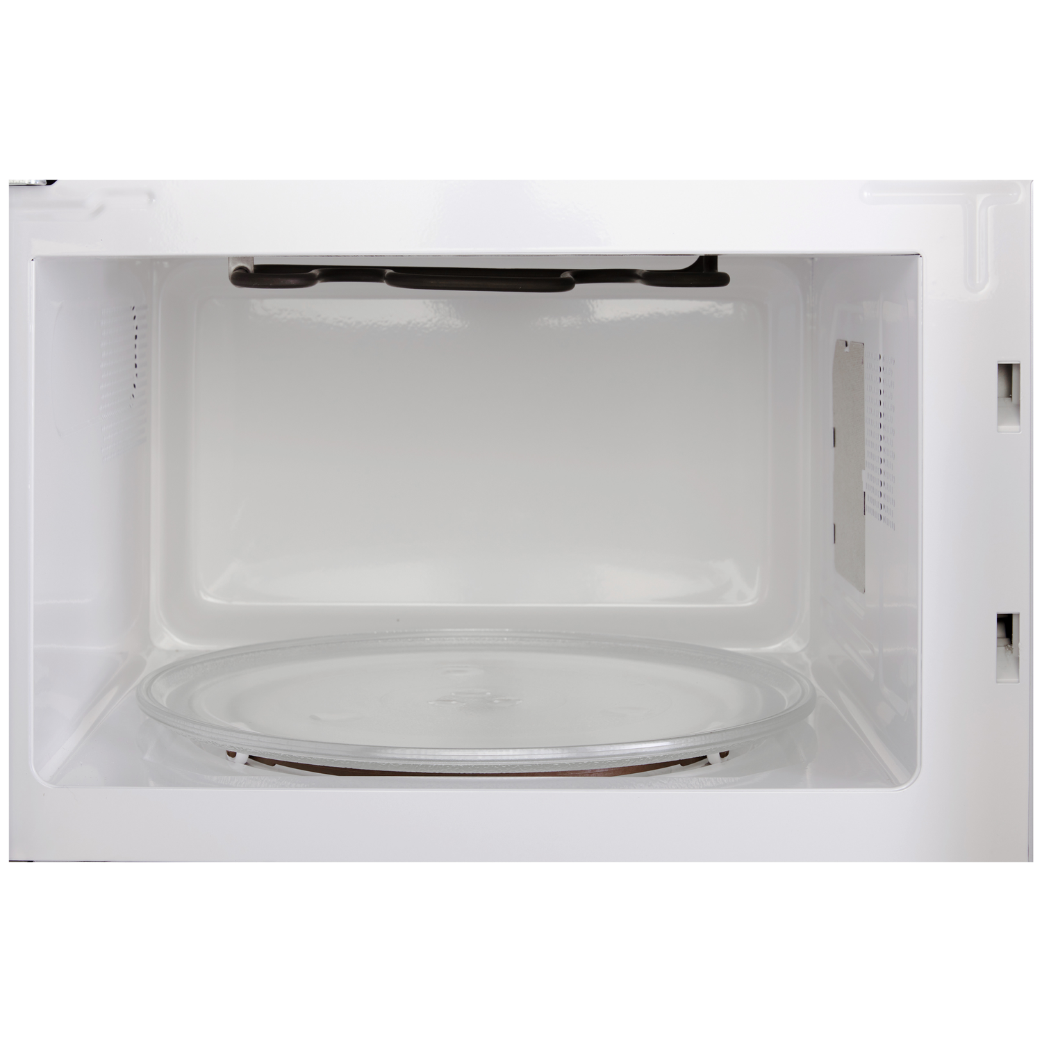 Interior of a clean, white microwave oven with a glass turntable and heating element.