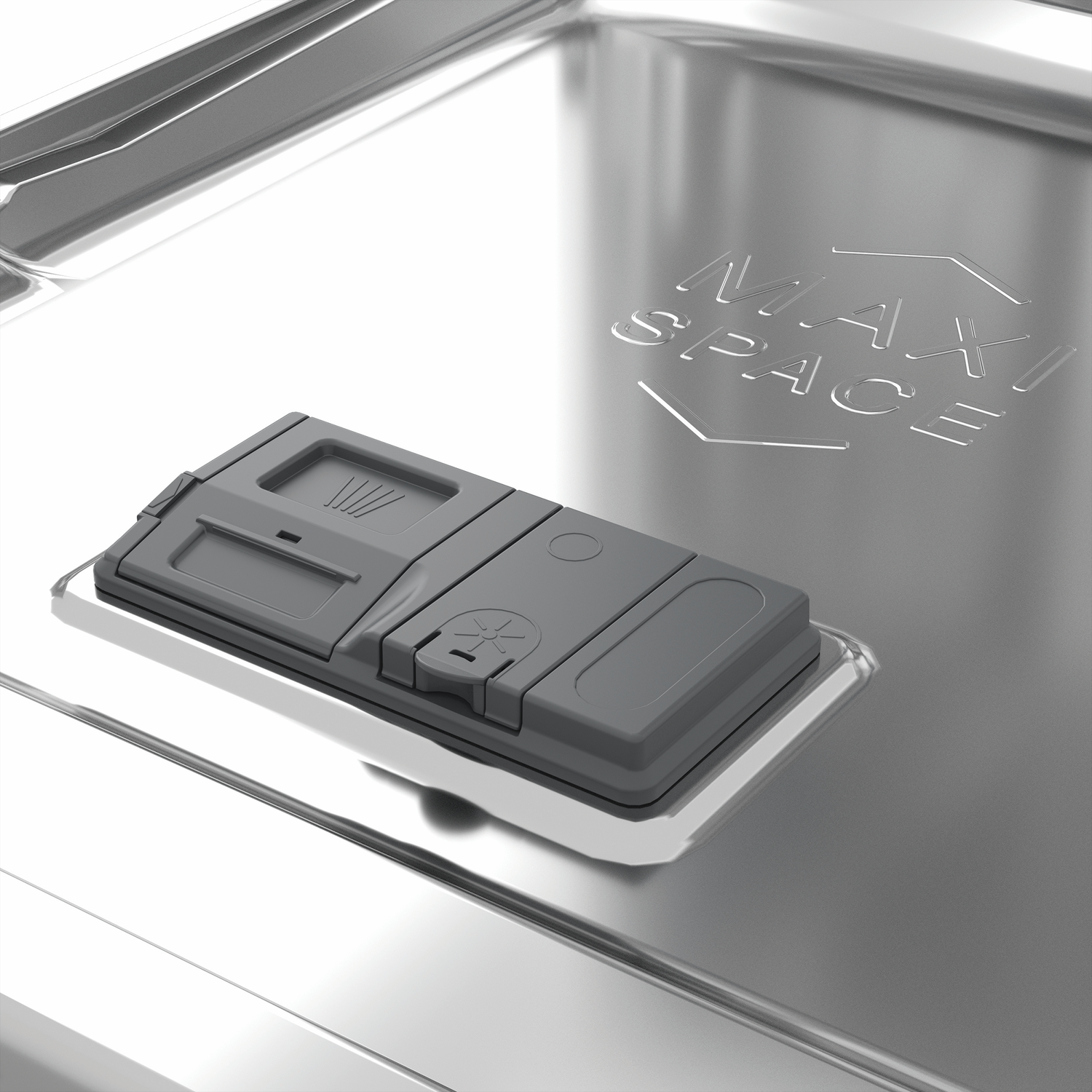 A gray dishwasher detergent dispenser sits on shiny metal with MAXI SPACE text.