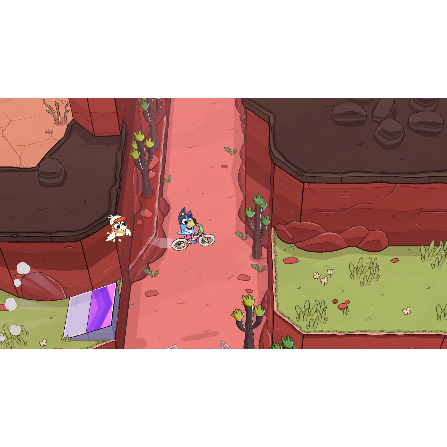 Bluey rides a bike on a red path with a bird flying nearby. Desert landscape.