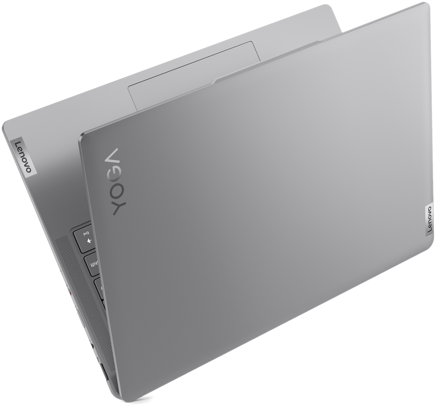 Un ordinateur portable Lenovo Yoga argenté est présenté en vue de dessus. Le capot est fermé.
