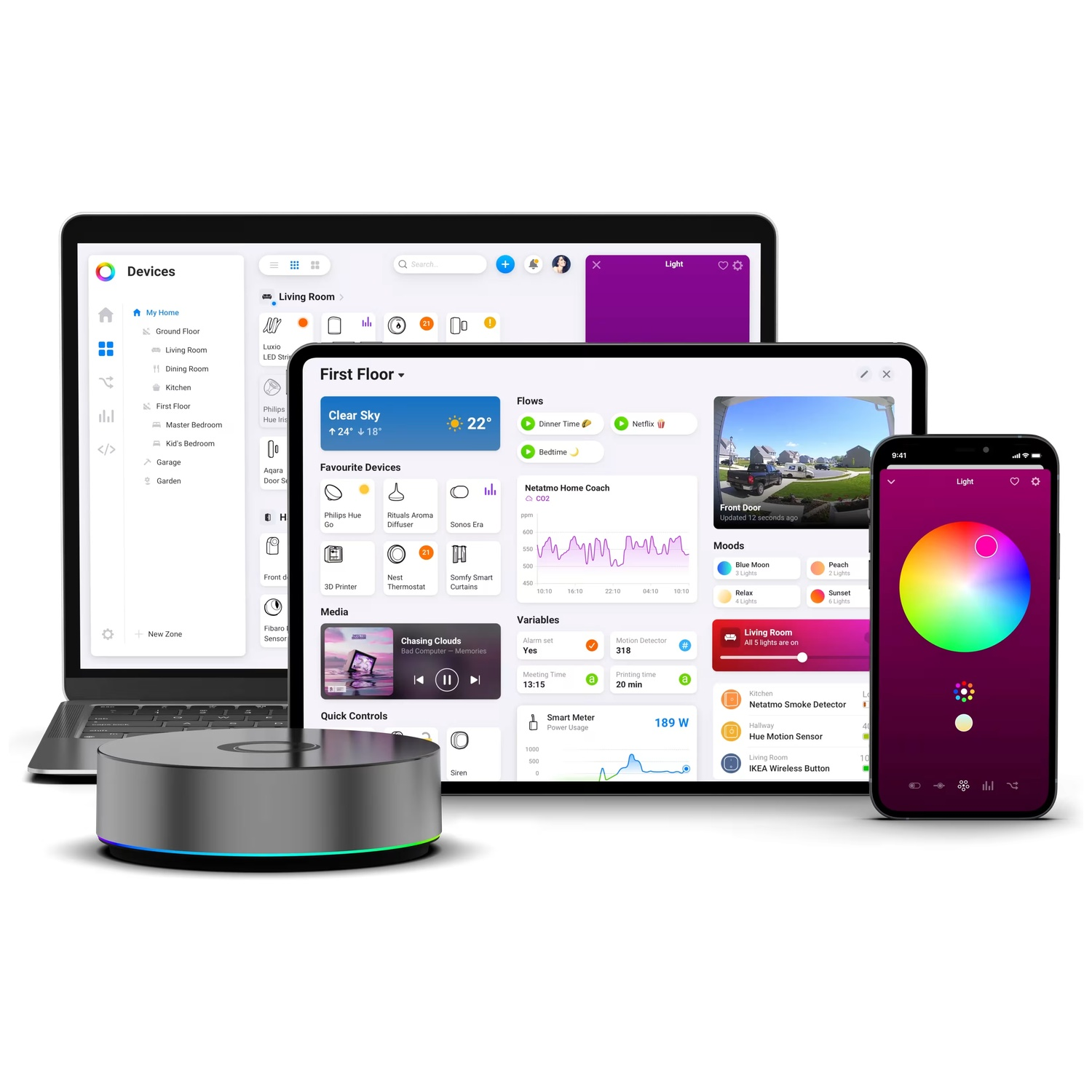 A smart home hub with a laptop, tablet, and phone displaying smart home controls.